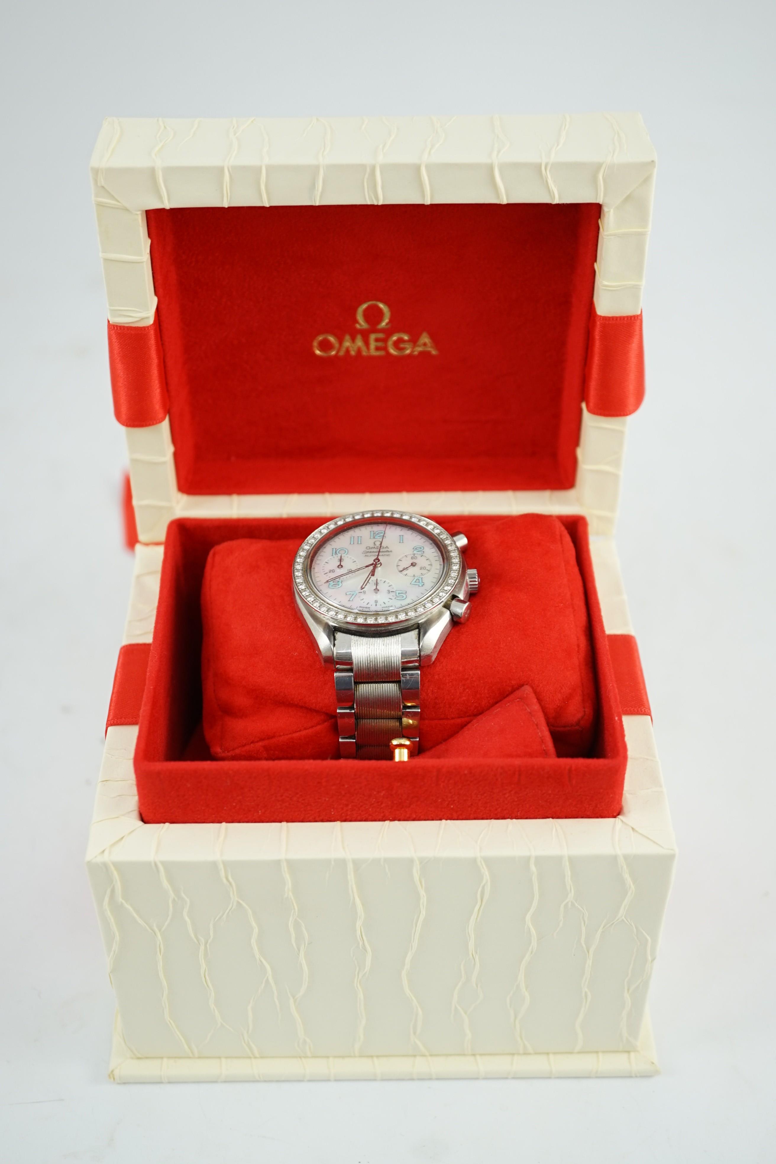 A lady's modern stainless steel Omega Speedmaster automatic wrist watch and bracelet, with mother of pearl Arabic dial and diamond set bezel